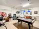 Finished garage converted into a game room featuring a pool table, foosball, and arcade games at 2548 Archfeld Blvd, Kissimmee, FL 34747