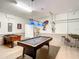 Finished garage converted into a game room featuring a pool table, foosball, and arcade games at 2548 Archfeld Blvd, Kissimmee, FL 34747