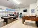 Finished garage converted into a game room featuring a pool table, foosball, and arcade games at 2548 Archfeld Blvd, Kissimmee, FL 34747