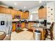 Well-equipped kitchen features stainless steel appliances, granite countertops, and wooden cabinets at 2548 Archfeld Blvd, Kissimmee, FL 34747