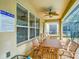 Inviting covered patio with a ceiling fan, dining table, and chairs at 2548 Archfeld Blvd, Kissimmee, FL 34747