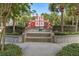 Elevated view of the castle themed playground surrounded by palm trees and trimmed hedges at 2548 Archfeld Blvd, Kissimmee, FL 34747