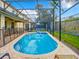 Relaxing screened pool with attached spa and blue basketball hoop under a bright blue sky at 2548 Archfeld Blvd, Kissimmee, FL 34747