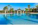 Resort-style pool surrounded by lush landscaping and comfortable lounge seating at 2548 Archfeld Blvd, Kissimmee, FL 34747