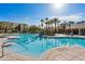 Inviting pool with a zero entry, community buildings, and lounge chairs at 2548 Archfeld Blvd, Kissimmee, FL 34747