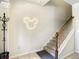 Staircase with carpeted steps, wooden banister and decorative mickey-mouse light at 2548 Archfeld Blvd, Kissimmee, FL 34747