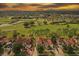 Stunning aerial view of the neighborhood homes backing onto a scenic golf course at sunset at 2630 Albion Ave, Orlando, FL 32833