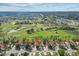 Stunning aerial view of homes backing up to a lush golf course with mature trees and scenic ponds at 2630 Albion Ave, Orlando, FL 32833