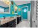 Colorful bathroom featuring dual vanities, unique nautical decorations, and a separate toilet and shower area at 2630 Albion Ave, Orlando, FL 32833