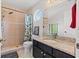 Bathroom featuring a granite countertop vanity, shower, and round window at 2630 Albion Ave, Orlando, FL 32833