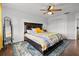 Bright bedroom with wood floors featuring a bed with storage drawers, ceiling fan, and area rug at 2630 Albion Ave, Orlando, FL 32833