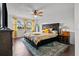 Spacious bedroom featuring a large bed, ceiling fan, and windows providing ample natural light at 2630 Albion Ave, Orlando, FL 32833