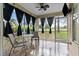 Inviting tiled porch with comfortable seating, ceiling fan, and scenic views of the golf course at 2630 Albion Ave, Orlando, FL 32833