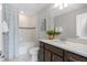 Bright bathroom featuring a shower-tub combination and dark wood vanity with a white countertop and sink at 2725 Serenity Garden Dr, Kissimmee, FL 34744