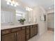 Elegant bathroom with double vanity, stylish mirrors, and plenty of storage space at 2725 Serenity Garden Dr, Kissimmee, FL 34744