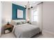 Stylish bedroom with a modern design featuring a geometric art piece and coordinated furniture at 2725 Serenity Garden Dr, Kissimmee, FL 34744