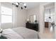 Comfortable bedroom showcasing modern furnishings and a large mirror on the dresser at 2725 Serenity Garden Dr, Kissimmee, FL 34744
