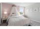 Charming bedroom with pink accents, a canopy bed, and a scenic window view at 2725 Serenity Garden Dr, Kissimmee, FL 34744