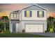 Charming two-story home with a two car garage, neutral siding, and beautiful sunset at 2725 Serenity Garden Dr, Kissimmee, FL 34744