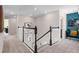 Upstairs hallway with modern railing and an office nook with blue accent wall at 2725 Serenity Garden Dr, Kissimmee, FL 34744