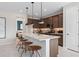 Modern kitchen features a center island with bar stool seating and stainless steel appliances at 2725 Serenity Garden Dr, Kissimmee, FL 34744