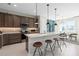 The kitchen features a large center island with seating, wood cabinets, and stainless appliances at 2725 Serenity Garden Dr, Kissimmee, FL 34744