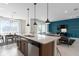 This modern kitchen features a large island, open layout, and stainless steel dishwasher at 2725 Serenity Garden Dr, Kissimmee, FL 34744