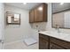 Functional laundry room with wall-mounted drying rack, upper cabinets, and utility sink with light countertops at 2725 Serenity Garden Dr, Kissimmee, FL 34744