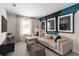 Comfortable loft area with modern decor, a sectional sofa, and stylish accent wall at 2725 Serenity Garden Dr, Kissimmee, FL 34744