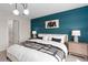 Cozy bedroom featuring a custom accent wall, modern lighting, and neutral colors at 2725 Serenity Garden Dr, Kissimmee, FL 34744