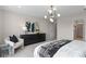 Stylish bedroom with modern lighting, a dark dresser, and comfortable sitting area at 2725 Serenity Garden Dr, Kissimmee, FL 34744