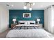 A beautifully styled bedroom with a patterned accent wall and bright, natural light at 2725 Serenity Garden Dr, Kissimmee, FL 34744
