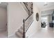 The carpeted staircase with white and wood banister leads to the upper level of the home at 2725 Serenity Garden Dr, Kissimmee, FL 34744
