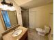 Bright bathroom featuring a granite vanity top, toilet, mirror, and walk-in shower at 2822 Bella Vista Dr, Davenport, FL 33897
