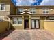 Charming townhouse with a brick-paved driveway, inviting entrance, and well-maintained landscaping at 2822 Bella Vista Dr, Davenport, FL 33897