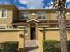 Charming townhouse with a brick-paved driveway, inviting entrance, and well-maintained landscaping at 2822 Bella Vista Dr, Davenport, FL 33897