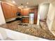 Charming kitchen featuring granite countertops, stainless steel appliances and wooden cabinetry at 2822 Bella Vista Dr, Davenport, FL 33897