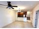 Open-concept living room featuring a ceiling fan, kitchen with breakfast bar, and staircase at 2822 Bella Vista Dr, Davenport, FL 33897