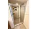 Tiled standing shower featuring glass door with tiled accents and shower head at 2822 Bella Vista Dr, Davenport, FL 33897
