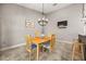 Cozy dining room featuring a wooden table with chairs, chandelier lighting, and neutral wall color at 2823 Deerfield St, St Cloud, FL 34771