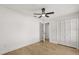 Bright bedroom featuring hardwood floors, ceiling fan, and closet at 2930 Paddington Way, Kissimmee, FL 34747