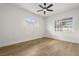 A light-filled bedroom with hardwood floors and a ceiling fan at 2930 Paddington Way, Kissimmee, FL 34747