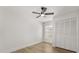 Bedroom features hardwood floors, a ceiling fan, and a closet at 2930 Paddington Way, Kissimmee, FL 34747