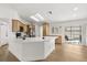 Modern kitchen with a large island, stainless steel appliances, and light wood cabinets at 2930 Paddington Way, Kissimmee, FL 34747
