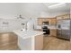 Bright kitchen with a large island, stainless steel appliances, and light wood cabinets at 2930 Paddington Way, Kissimmee, FL 34747