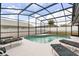 Private pool with screen enclosure and lounge chairs at 2930 Paddington Way, Kissimmee, FL 34747
