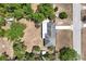 Overhead view of the home's roof and fully fenced yard surrounded by mature trees at 295 W Charlotte Ave, Eustis, FL 32726