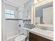 Updated bathroom with white subway tile, a modern vanity, and a shower-tub combo at 295 W Charlotte Ave, Eustis, FL 32726
