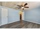 Bright bedroom with hardwood floors, a ceiling fan and multiple closets at 295 W Charlotte Ave, Eustis, FL 32726