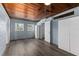 Comfortable bedroom with wood ceiling, light blue walls, and gray laminate flooring at 295 W Charlotte Ave, Eustis, FL 32726